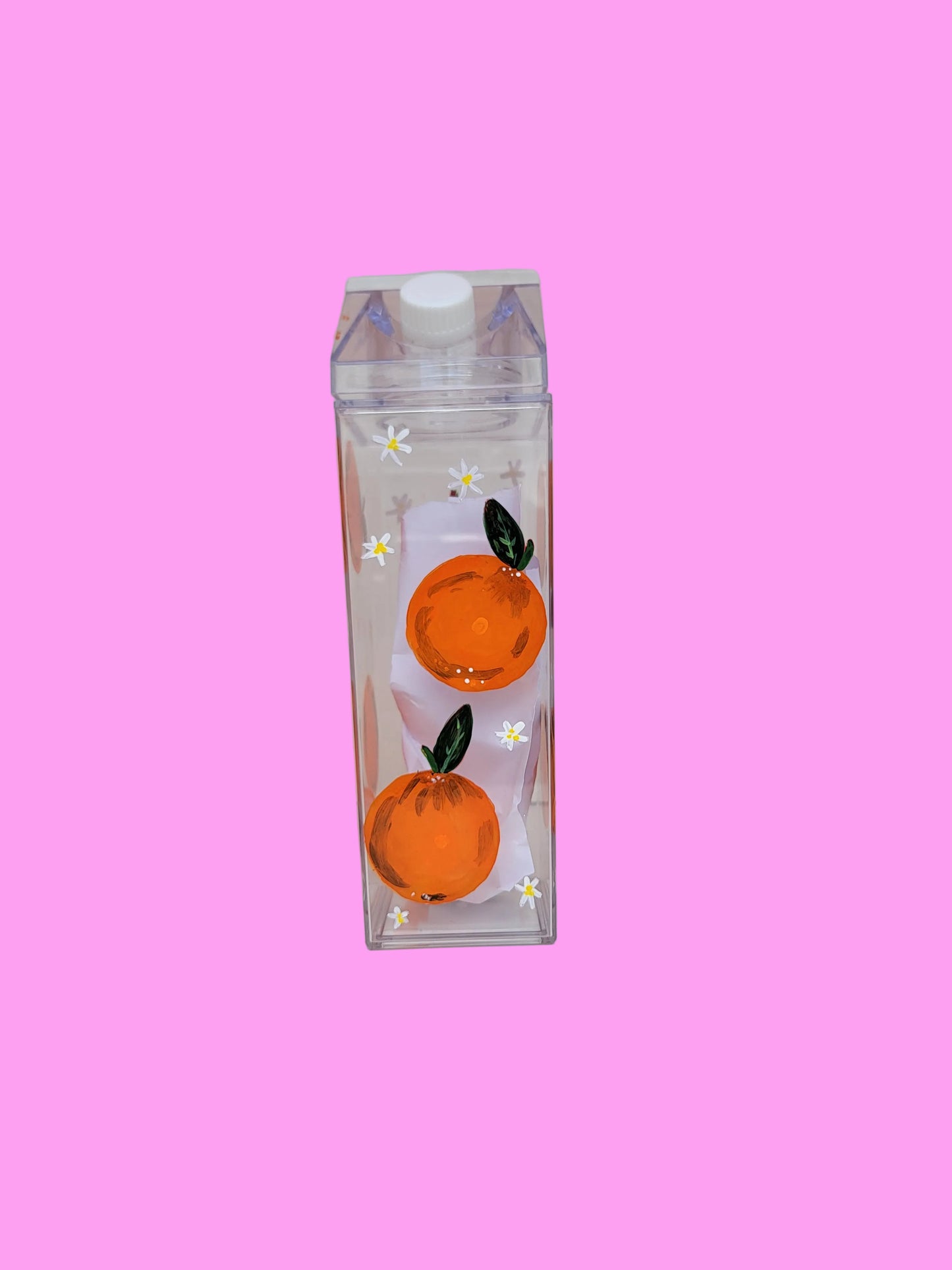 Oranges on milk bottle